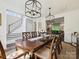 Elegant dining area featuring a large table, decorative lighting, and easy access to the living room at 5420 Meadowcroft Way, Fort Mill, SC 29708