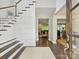 Bright, modern foyer featuring wood floors, staircase, and an open floor plan at 5420 Meadowcroft Way, Fort Mill, SC 29708