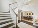 Bright foyer leading to a dining room with an elegant chandelier and an adjacent staircase with wood treads at 5420 Meadowcroft Way, Fort Mill, SC 29708