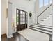 Bright, two story foyer featuring wood floors, high ceilings, and staircase at 5420 Meadowcroft Way, Fort Mill, SC 29708