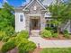Close up of stone accented front entry, showing landscaping and wood door at 5420 Meadowcroft Way, Fort Mill, SC 29708