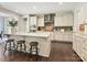 Modern kitchen features white cabinets, granite countertops, an island with barstool seating, and stainless appliances at 5420 Meadowcroft Way, Fort Mill, SC 29708