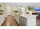 Well-lit kitchen featuring an island with a sink, stainless steel appliances, and seamless access to the living area at 5420 Meadowcroft Way, Fort Mill, SC 29708
