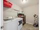 Functional laundry room with modern appliances, storage shelves, and tiled floor at 5420 Meadowcroft Way, Fort Mill, SC 29708