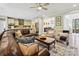 Spacious living room featuring a large leather sectional sofa and open-concept kitchen and dining area at 5420 Meadowcroft Way, Fort Mill, SC 29708