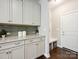 A well-lit mudroom features custom cabinets, a tiled backsplash, and a convenient bench with storage at 5420 Meadowcroft Way, Fort Mill, SC 29708