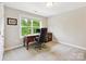 Bright home office with a traditional desk, large window, and neutral carpet at 5420 Meadowcroft Way, Fort Mill, SC 29708
