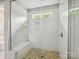 Modern walk-in shower with a pebble floor, white subway tile, a rain shower head, and a built-in bench at 5420 Meadowcroft Way, Fort Mill, SC 29708