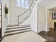 Staircase with white railing, dark wood steps, and detailed wall paneling at 5420 Meadowcroft Way, Fort Mill, SC 29708