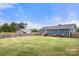 Expansive fenced backyard featuring lush green grass and a charming shed, ideal for outdoor activities at 5528 Little Mountain Rd, Gastonia, NC 28056