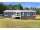 Inviting blue home with brick foundation, white trim, and a charming front porch offers curb appeal at 5528 Little Mountain Rd, Gastonia, NC 28056