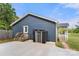 View of the home's side exterior includes a small porch with steps and shed for outdoor storage at 5528 Little Mountain Rd, Gastonia, NC 28056