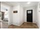 Bright foyer with wood-look floors and a view into the main bedroom at 5528 Little Mountain Rd, Gastonia, NC 28056