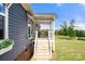 Inviting front porch with stairs leading to a cozy seating area at 5528 Little Mountain Rd, Gastonia, NC 28056