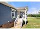 Inviting front porch with stairs leading to a cozy seating area at 5528 Little Mountain Rd, Gastonia, NC 28056
