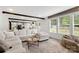 Open concept living room with large windows and view to backyard at 5528 Little Mountain Rd, Gastonia, NC 28056