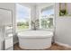 Bright bathroom with stand alone soaking tub, wood floors, and plenty of natural light at 5528 Little Mountain Rd, Gastonia, NC 28056
