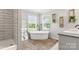 Bright bathroom with stand alone soaking tub, wood floors, stand up shower, and plenty of natural light at 5528 Little Mountain Rd, Gastonia, NC 28056