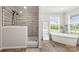 Bright bathroom with stand alone soaking tub, wood floors, and stand up shower at 5528 Little Mountain Rd, Gastonia, NC 28056