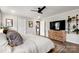 Bright main bedroom featuring a ceiling fan, wood floors, TV, and ensuite bathroom at 5528 Little Mountain Rd, Gastonia, NC 28056