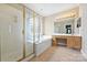 Bright bathroom with a soaking tub, vanity, and a standing shower at 5940 Four Wood Dr, Matthews, NC 28104