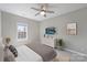 Relaxing bedroom features soft carpet, a ceiling fan, and natural light filtering through a large window at 5940 Four Wood Dr, Matthews, NC 28104
