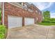 Brick house exterior features an attached two-car garage and paved driveway at 5940 Four Wood Dr, Matthews, NC 28104