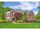 Beautiful brick house with manicured lawn and mature landscaping at 5940 Four Wood Dr, Matthews, NC 28104