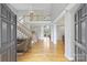 Bright foyer with hardwood floors, a staircase with white railing and a view into the living space at 5940 Four Wood Dr, Matthews, NC 28104