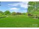 Scenic view of the golf course with lush green grass and mature trees on a sunny day at 5940 Four Wood Dr, Matthews, NC 28104