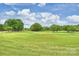 Expansive golf course with lush green fairways and mature trees under a partly cloudy sky at 5940 Four Wood Dr, Matthews, NC 28104
