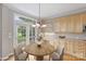 Bright eat-in kitchen with wooden cabinets, breakfast nook, and backyard access at 5940 Four Wood Dr, Matthews, NC 28104