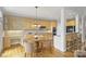 Spacious kitchen with wooden cabinetry, center island with seating and eat-in breakfast nook at 5940 Four Wood Dr, Matthews, NC 28104