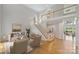 Bright and airy living room features hardwood floors, staircase, and neutral decor at 5940 Four Wood Dr, Matthews, NC 28104