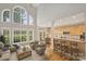 Bright open living space with large windows, hardwood floors, and breakfast bar to adjacent kitchen at 5940 Four Wood Dr, Matthews, NC 28104