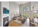 Sunlit living room with a vaulted ceiling, fireplace, and a view to the yard at 5940 Four Wood Dr, Matthews, NC 28104