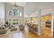 Spacious living room with a vaulted ceiling, hardwood floors, and an open kitchen at 5940 Four Wood Dr, Matthews, NC 28104