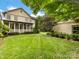 Expansive backyard features a well-maintained lawn, a screened porch, and mature landscaping at 601 Dorothy Dr, Charlotte, NC 28203