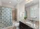 Bathroom featuring a vanity with granite countertop, neutral tile flooring, and a shower/tub combination at 601 Dorothy Dr, Charlotte, NC 28203
