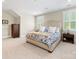 Bright bedroom featuring a king-size bed with blue-patterned bedding and multiple windows with white shutters at 601 Dorothy Dr, Charlotte, NC 28203