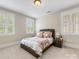 Cozy bedroom with plush carpet, windows with shutters, and a bed with floral bedding at 601 Dorothy Dr, Charlotte, NC 28203
