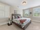 Bright bedroom with plush carpet, windows with shutters, and a king bed with patterned bedding at 601 Dorothy Dr, Charlotte, NC 28203