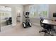 Bright exercise room with an elliptical machine, large windows with shutter blinds, and an adjacent bathroom at 601 Dorothy Dr, Charlotte, NC 28203