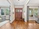 Inviting foyer featuring hardwood floors and a solid wood front door with sidelights at 601 Dorothy Dr, Charlotte, NC 28203