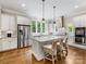 Bright kitchen featuring a large island with granite counters, stainless appliances and hardwood floors at 601 Dorothy Dr, Charlotte, NC 28203