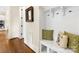 Mudroom with built-in bench seating, coat hooks, and hardwood flooring at 601 Dorothy Dr, Charlotte, NC 28203