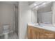 Modern bathroom with a glass shower, and wood vanity with white countertop at 625 N Alexander St, Charlotte, NC 28202