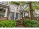 Charming townhome exterior with covered front porch and well-manicured landscaping at 625 N Alexander St, Charlotte, NC 28202