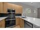 Modern kitchen with sleek appliances, black backsplash, quartz countertops, and ample cabinet space at 625 N Alexander St, Charlotte, NC 28202