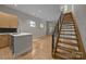 Spacious living area with hardwood floors, staircase, and modern kitchen in the background at 625 N Alexander St, Charlotte, NC 28202